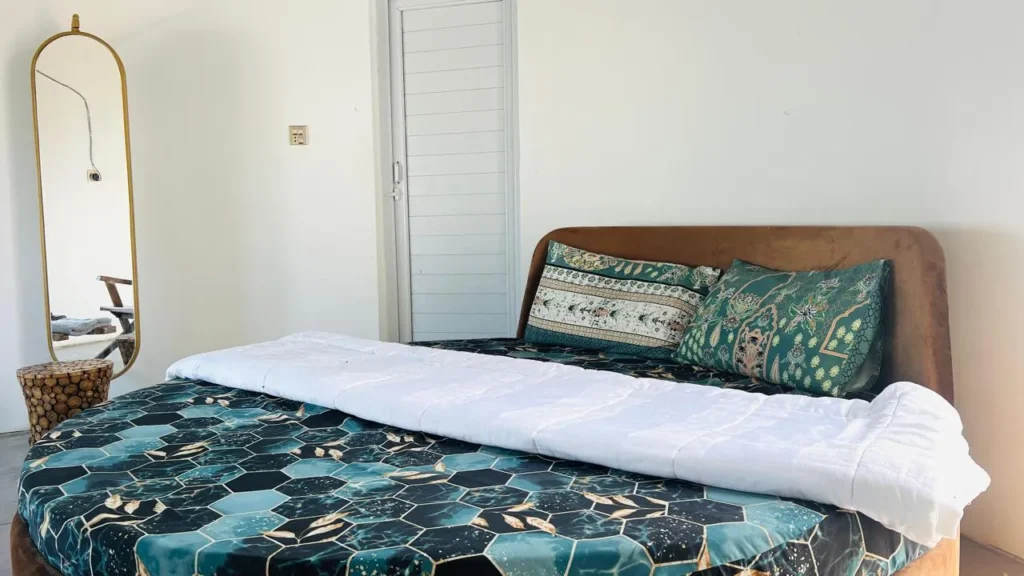 Interior of luxury room featuring modern and comfortable king size bed, furniture